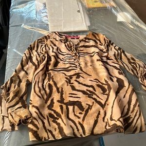 Skin is in! Leopard patterned silk top with details at neck and sleeves.
